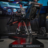 High-tech gaming simulator with 'Driven Dynamix' branding in a dark room.