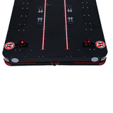 Black air hockey table with red and white accents on a white background