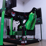 Gaming chair with green accents and visible brand logo in a room setting